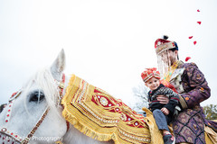 Lovely take of the Indian groom riding the ghodi during the baraat Lovely take of the Indian groom riding the ghodi during the baraat