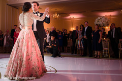 Lovely Indian couple having their first dance as guests observe Lovely Indian couple having their first dance as guests observe