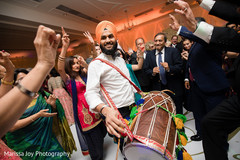 Guests dance to the dhol at the Indian wedding reception Guests dance to the dhol at the Indian wedding reception