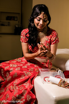 Sweet indian bride putting bangles on. Sweet indian bride putting bangles on.