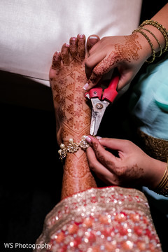 Indian bride being helped by putting her anklets. Indian bride being helped by putting her anklets.