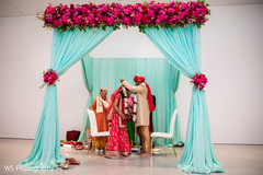 Indian groom putting flower garland to bride. Indian groom putting flower garland to bride.