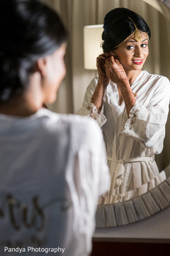 Indian bride getting her earrings on. Indian bride getting her earrings on.