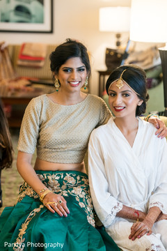 Joyful Indian bride and bridesmaid getting ready for wedding. Joyful Indian bride and bridesmaid getting ready for wedding.