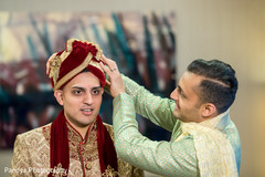 Indian groom getting help with his turban. Indian groom getting help with his turban.