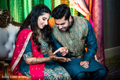 Lovely Indian wedding couple looking at mehndi art. Lovely Indian wedding couple looking at mehndi art.