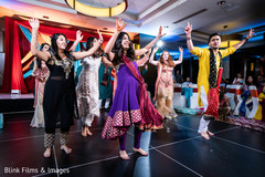 Indian pre-wedding guests celebrating with a dance. Indian pre-wedding guests celebrating with a dance.