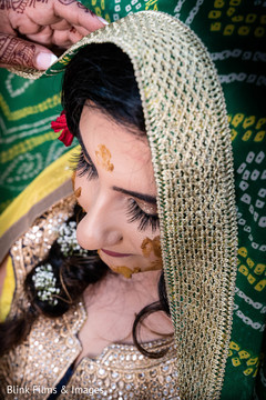 Indian bride getting the turmeric paste on her face. Indian bride getting the turmeric paste on her face.