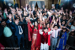 Indian bride and groom with wedding guests photography.