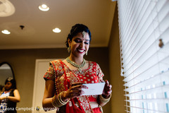 Indian bride smiles as she reads the message from the Raja Indian bride smiles as she reads the message from the Raja