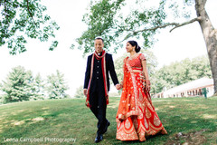 Dazzling Indian couple walking outdoors prior to the ceremonies Dazzling Indian couple walking outdoors prior to the ceremonies