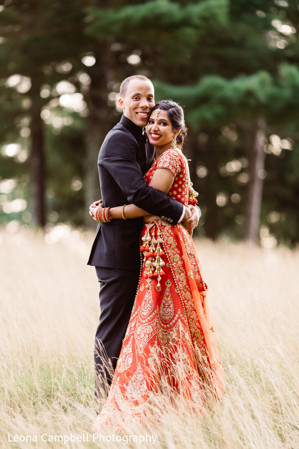 Joyful Indian couple hold each other as the ceremony comes closer ...