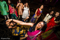 Indian pre-wedding guests celebrating with a dance. Indian pre-wedding guests celebrating with a dance.