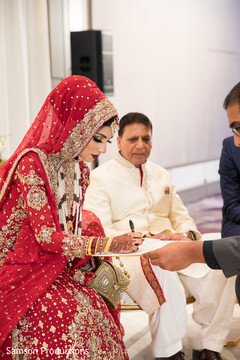 Indian bride signing her marriage contract Indian bride signing her marriage contract
