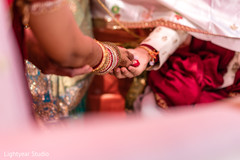 Indian bride and groom holding red rose petals. Indian bride and groom holding red rose petals.