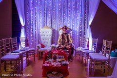 Elegant raja wearing the sherwani and pagri under the decor Elegant raja wearing the sherwani and pagri under the decor