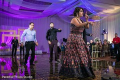 Guests perform during the Indian wedding reception Guests perform during the Indian wedding reception