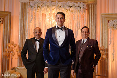 Indian groom posing for pictures with special guests at the venue Indian groom posing for pictures with special guests at the venue