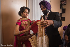 Awesome capture of Indian groom being assisted with the pagri Awesome capture of Indian groom being assisted with the pagri