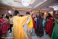 Indian couple dancing during sangeet Indian couple dancing during sangeet