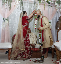 Indian bride and groom at their varmala ceremony Indian bride and groom at their varmala ceremony