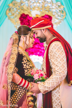 Indian bride and groom's romantic first look moment. Indian bride and groom's romantic first look moment.