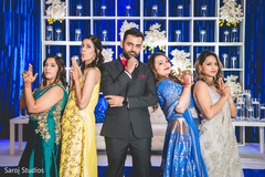 Creative capture of Indian groom with bridesmaids. Creative capture of Indian groom with bridesmaids.