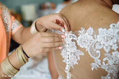 Indian bride getting her white dress on. Indian bride getting her white dress on.