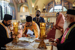 Indian Christian priest signing wedding document. Indian Christian priest signing wedding document.
