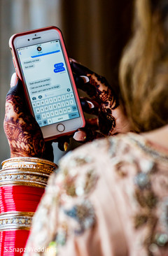 Excelent shot of Indian bride reading the raja's text message Excelent shot of Indian bride reading the raja's text message