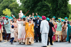 Indian groom and joyful guests during the baraat Indian groom and joyful guests during the baraat