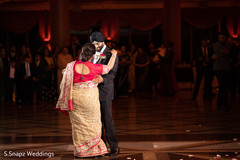 Indian groom dancing with a family member during the reception Indian groom dancing with a family member during the reception