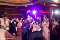 Indian groom having a blast during the ceremony Indian groom having a blast during the ceremony