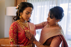 Sweet indian bride getting her jewelry on. Sweet indian bride getting her jewelry on.