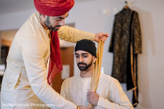 indian groom getting his pagdi on. indian groom getting his pagdi on.