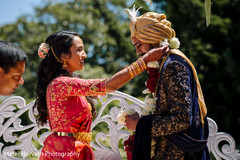 Indian bride putting flower garland to groom. Indian bride putting flower garland to groom.
