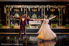 Gleeful indian bride and groom's wedding reception dance. Gleeful indian bride and groom's wedding reception dance.
