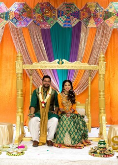 Indian couple posing for pictures under the mandap Indian couple posing for pictures under the mandap