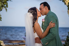 Adorable Indian bride being kissed by groom. Adorable Indian bride being kissed by groom.