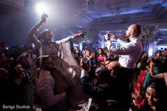 Indian bride being lifted by guests during the dance Indian bride being lifted by guests during the dance