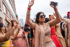 Indian guest dancing to the baraat outdoors Indian guest dancing to the baraat outdoors
