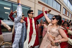 Indian wedding guests having a blast during the baraat Indian wedding guests having a blast during the baraat