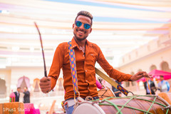 Capture of cheerful guest playing the dhol Capture of cheerful guest playing the dhol