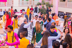 Joyful guests dancing to the dhol sounds Joyful guests dancing to the dhol sounds