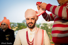 Raja being assisted with the pagri Raja being assisted with the pagri