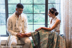 Indian groom admiring bridals henna art. Indian groom admiring bridals henna art.