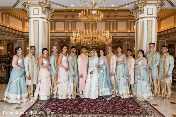 Stylish indian bride and groom with bridesmaids and groomsmen capture.