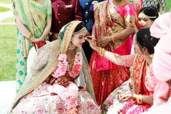 Indian bride getting the red dot on her forehead. Indian bride getting the red dot on her forehead.