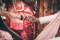 Indian bride and groom holding hands close up Indian bride and groom holding hands close up