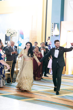 Lovely couple making their entrance to the wedding reception. Lovely couple making their entrance to the wedding reception.